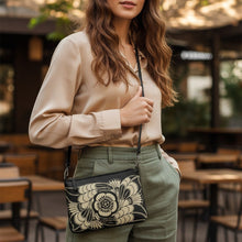 Load image into Gallery viewer, Melodia Gallery Art Nouveau floral crossbody bag in black faux leather with beige floral design and dark gray hardware.