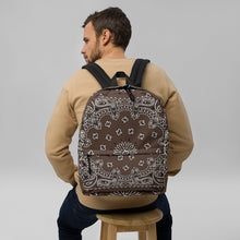 Load image into Gallery viewer, Melodia Gallery brown bandana print polyester backpack with white paisley design, featuring multiple pockets and padded straps.