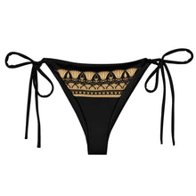 Load image into Gallery viewer, Melodia Gallery black bikini bottom with gold Egyptian lotus pattern and adjustable side ties. Made from recycled polyester and elastane.