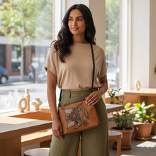 Load image into Gallery viewer, Melodia Gallery cognac faux leather crossbody bag with vintage Ukrainian folk art bird and floral design. Adjustable strap.
