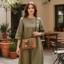 Load image into Gallery viewer, Melodia Gallery cognac faux leather crossbody bag with vintage Ukrainian folk art bird and floral design. Adjustable strap.
