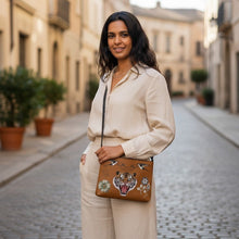 Load image into Gallery viewer, Melodia Gallery cognac faux leather crossbody bag with vintage Minhwa tiger, swallows, and floral art. Adjustable strap.