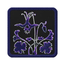 Load image into Gallery viewer, Melodia Gallery embroidered patch featuring a purple and silver Columbine flower on a black background with a navy border.