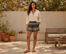 Load image into Gallery viewer, Melodia Gallery black cotton shorts with gold Egyptian lotus pattern, elastic waistband, boho style.