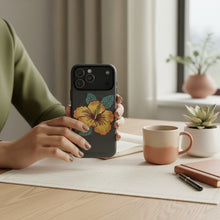 Load image into Gallery viewer, Melodia Gallery dark grey MagSafe tough case with yellow hibiscus flower and teal leaves