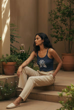 Load image into Gallery viewer, Melodia Gallery navy blue 100% cotton micro rib crop tank with lotus bloom graphic. Model wears tan pants.