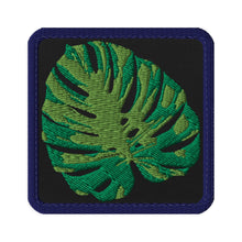 Load image into Gallery viewer, Melodia Gallery Monstera leaf embroidered tactical patch with hook and loop backing. Green leaf on black background with navy border.