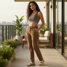 Load image into Gallery viewer, Melodia Gallery dark brown sports bra with white paisley print, scoop neckline, racerback, and wide elastic band.