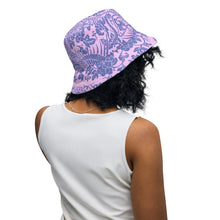 Load image into Gallery viewer, Melodia Gallery reversible bucket hat with a purple and blue floral phoenix pattern. Offers sun protection.