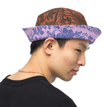Load image into Gallery viewer, Melodia Gallery reversible bucket hat with phoenix and floral pattern in earth tones and lavender/blue hues.