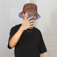 Load image into Gallery viewer, Melodia Gallery reversible bucket hat with phoenix and floral pattern in earth tones on one side, lavender and blue on the other.