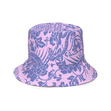 Load image into Gallery viewer, Melodia Gallery reversible bucket hat with a pink base and blue floral and phoenix pattern. Offers sun protection.