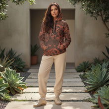 Load image into Gallery viewer, Melodia Gallery unisex cotton hoodie in rust with black floral and phoenix print, featuring a relaxed fit, drawstring hood, and front pocket.