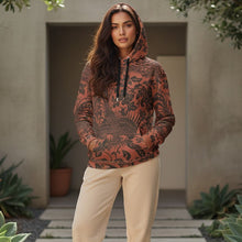 Load image into Gallery viewer, Melodia Gallery unisex cotton hoodie in rust with black floral and phoenix print, featuring a relaxed fit, drawstring hood, and front pocket.