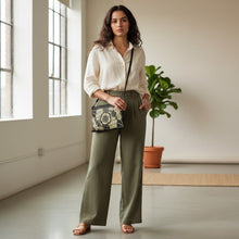 Load image into Gallery viewer, Melodia Gallery Art Nouveau floral crossbody bag in black faux leather with beige floral design and dark gray hardware.
