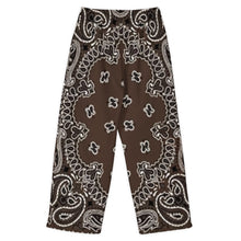 Load image into Gallery viewer, Melodia Gallery unisex brown bandana print wide leg pants made of cotton and elastane.
