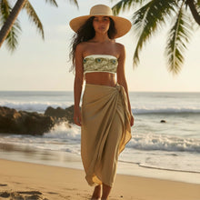 Load image into Gallery viewer, Melodia Gallery Art Nouveau Recycled Bandeau Bikini Top with peacock feather print, white and green. Model wears a straw hat and tan sarong on a beach.
