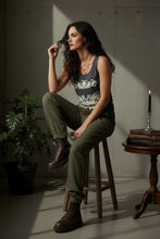 Load image into Gallery viewer, Melodia Gallery dark grey 100% cotton tank top with vintage bats art nouveau graphic. Model wears olive green joggers and brown boots.
