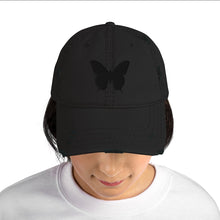 Load image into Gallery viewer, Melodia Gallery black distressed cotton dad hat with embroidered butterfly detail. Adjustable strap, fits most.
