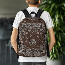 Load image into Gallery viewer, Melodia Gallery brown and white bandana print polyester backpack with padded straps and multiple pockets.
