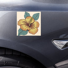 Load image into Gallery viewer, Melodia Gallery yellow hibiscus flower car magnet with green leaves on a cream background. Weather-resistant, US Made.
