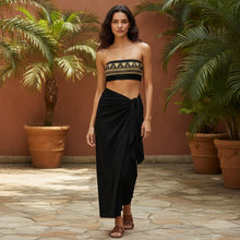 Load image into Gallery viewer, Melodia Gallery black bandeau bikini top with gold Egyptian lotus pattern. Recycled polyester, UPF 50+.

