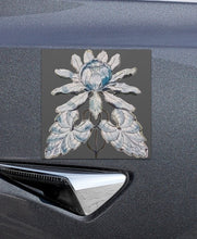 Load image into Gallery viewer, Melodia Gallery lotus bloom vintage art car magnet with blue and white floral design on a dark grey background.
