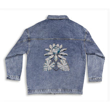 Load image into Gallery viewer, Melodia Gallery blue denim jacket with oversized fit and lotus graphic on back. Long sleeves, button front, and chest pockets.
