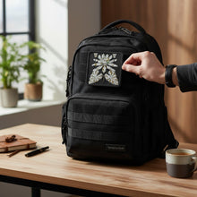 Load image into Gallery viewer, Melodia Gallery embroidered tactical patch featuring a white and gold lotus bloom with green accents on a black background. Hook and loop backing.
