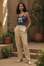 Load image into Gallery viewer, Melodia Gallery navy blue 100% cotton micro rib crop tank with lotus bloom graphic. Model wears tan pants.
