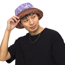 Load image into Gallery viewer, Melodia Gallery reversible bucket hat with intricate phoenix and floral pattern in earth tones and lavender/blue hues.
