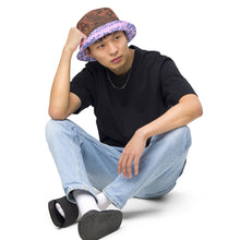 Load image into Gallery viewer, Melodia Gallery Phoenix + Flora Reversible Bucket Hat in earth tones and lavender/blue, featuring intricate phoenix and floral patterns.
