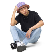 Load image into Gallery viewer, Melodia Gallery Phoenix + Flora Reversible Bucket Hat with intricate pattern and earth tones on one side, lavender and blue on the other.
