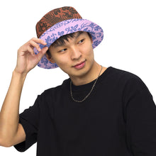 Load image into Gallery viewer, Melodia Gallery reversible bucket hat with brown phoenix/flora pattern and lavender/blue floral pattern. Soft fabric.

