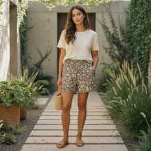 Load image into Gallery viewer, Melodia Gallery unisex long shorts in beige and dark brown floral print, made of cotton with a relaxed fit.
